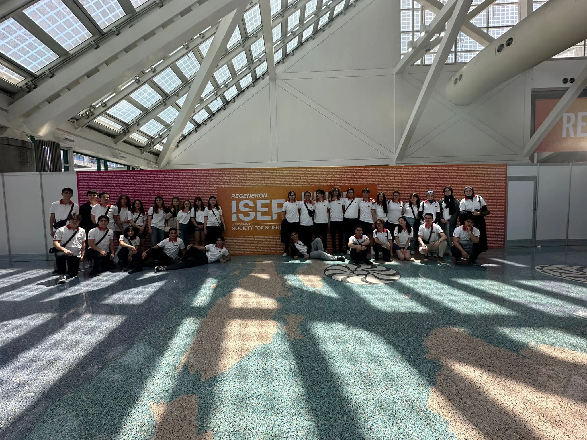 Image of the Türkiye team in front of the famous ISEF name wall.